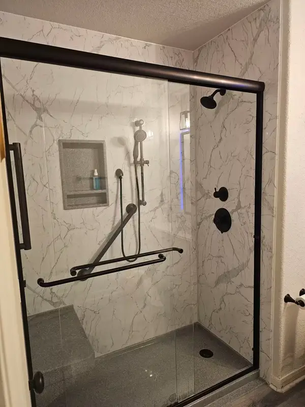 Completed tub-to-shower conversion with Santorini White finish and Venetian Bronze fixtures
