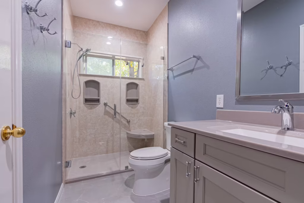 Accessible walk-in shower with beige marble walls and built-in grab bars