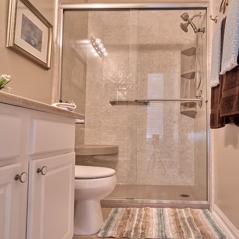 Small bathroom with white vanity and walk-in shower