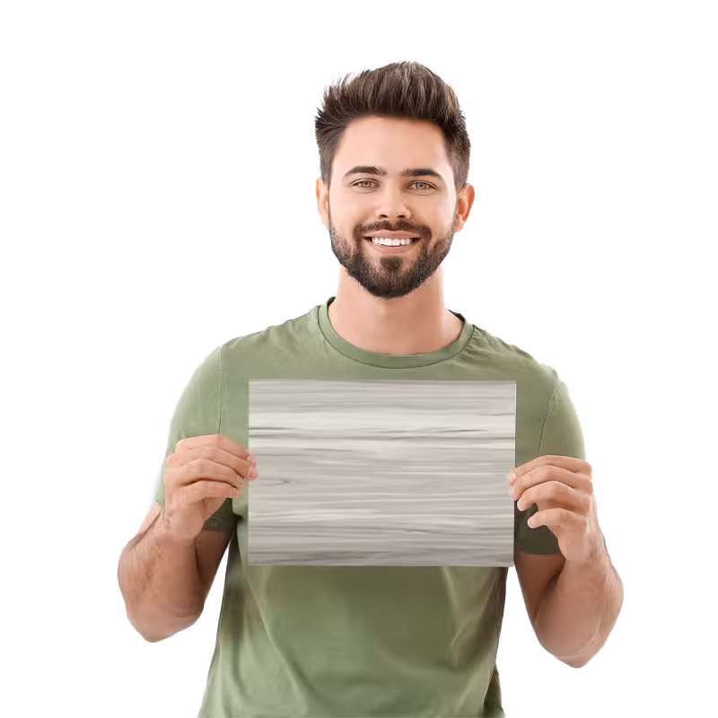 Smiling man holding a Horizon Beige solid surface wall panel sample for bathroom remodeling.