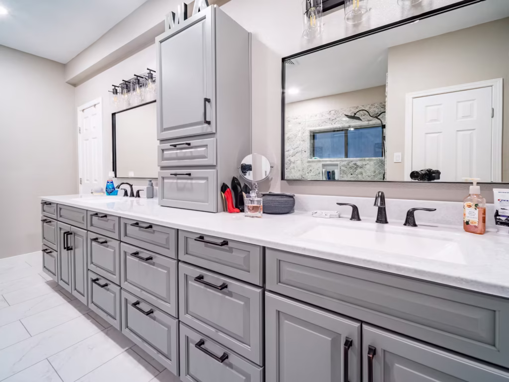 Modern gray double vanity with white solid surface countertop in Houston bathroom remodel by EZ Bath