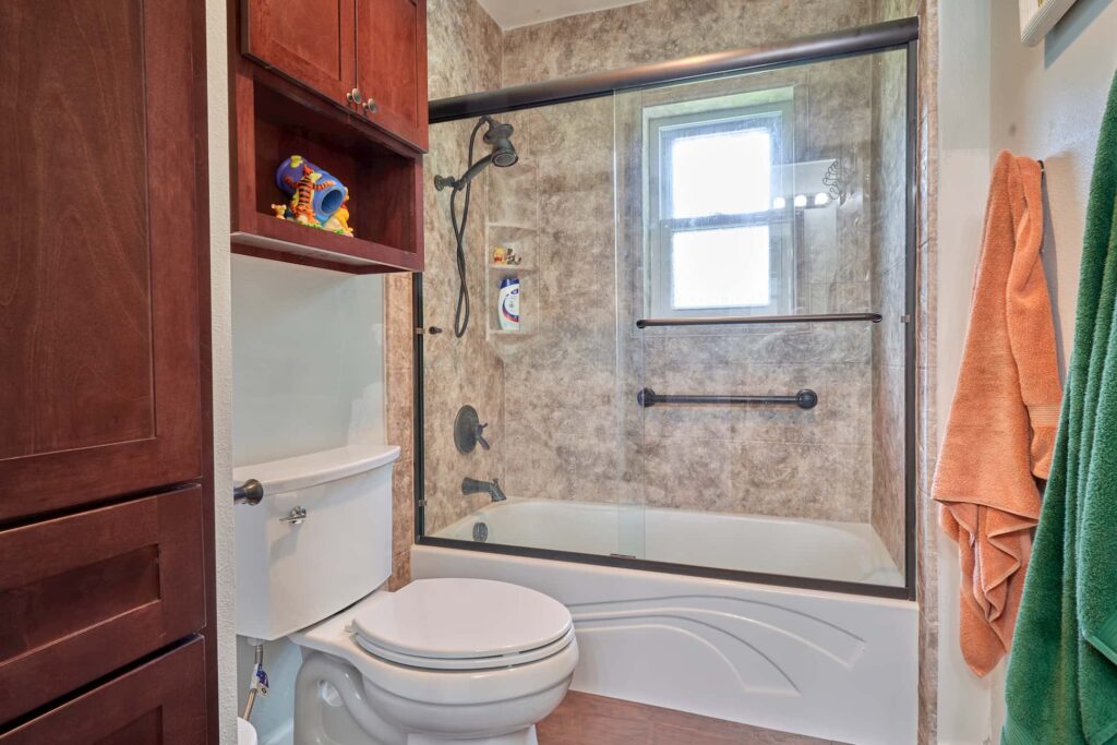 Tub Shower Combo With Wood Cabinetry