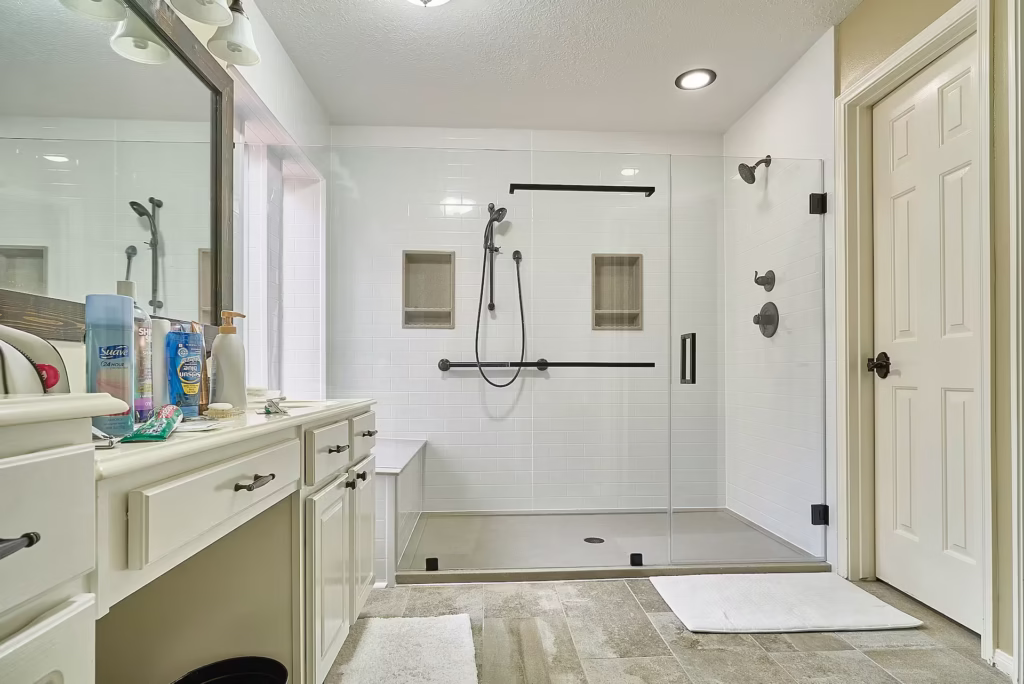 Large walk-in shower with dual showerheads and white subway tile walls