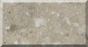 Beige textured stone surface with subtle white spots.